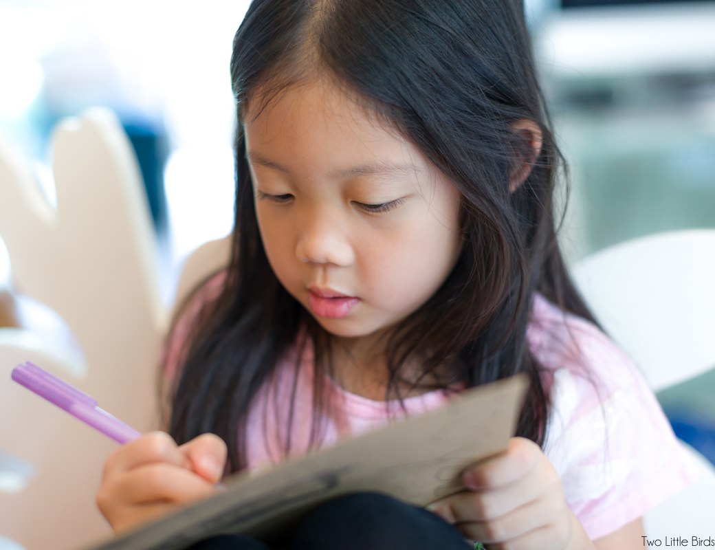 student writing in notebook